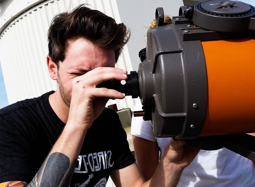 Male students using a telescope.